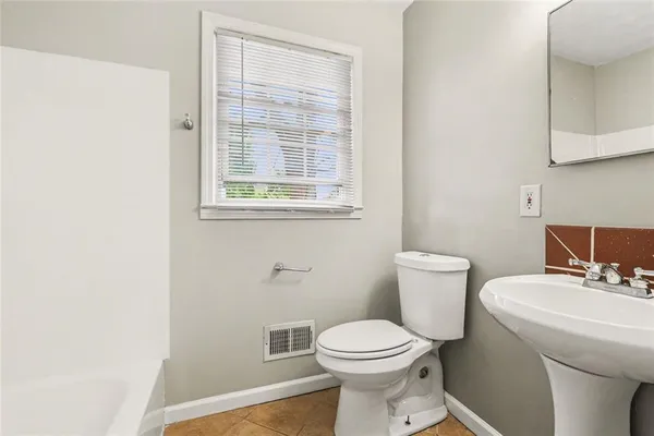 a white toilet sitting next to a bathroom sink