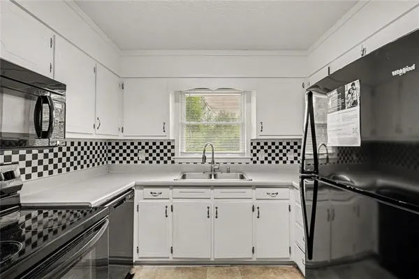 a kitchen with a sink stove and microwave
