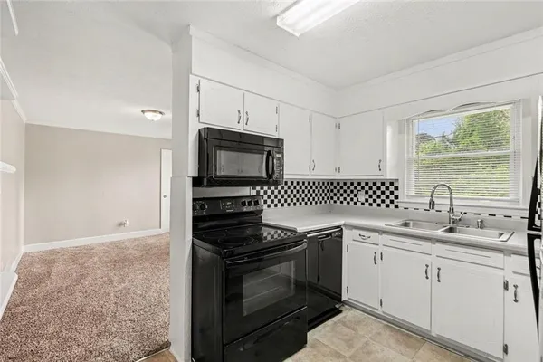 a kitchen with a sink stove and microwave