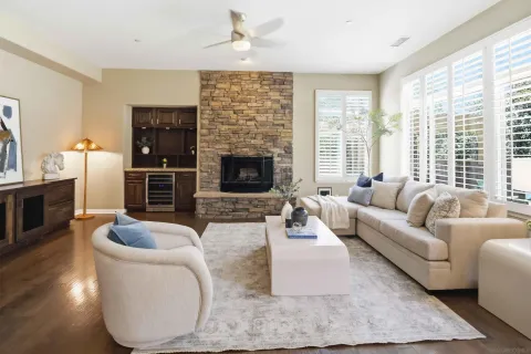 a kitchen with stainless steel appliances granite countertop a table chairs refrigerator and a sink