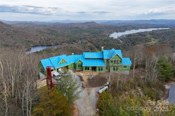 an aerial view of a house with a yard basket ball court and outdoor seating