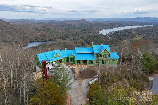 an aerial view of a house with a yard basket ball court and outdoor seating