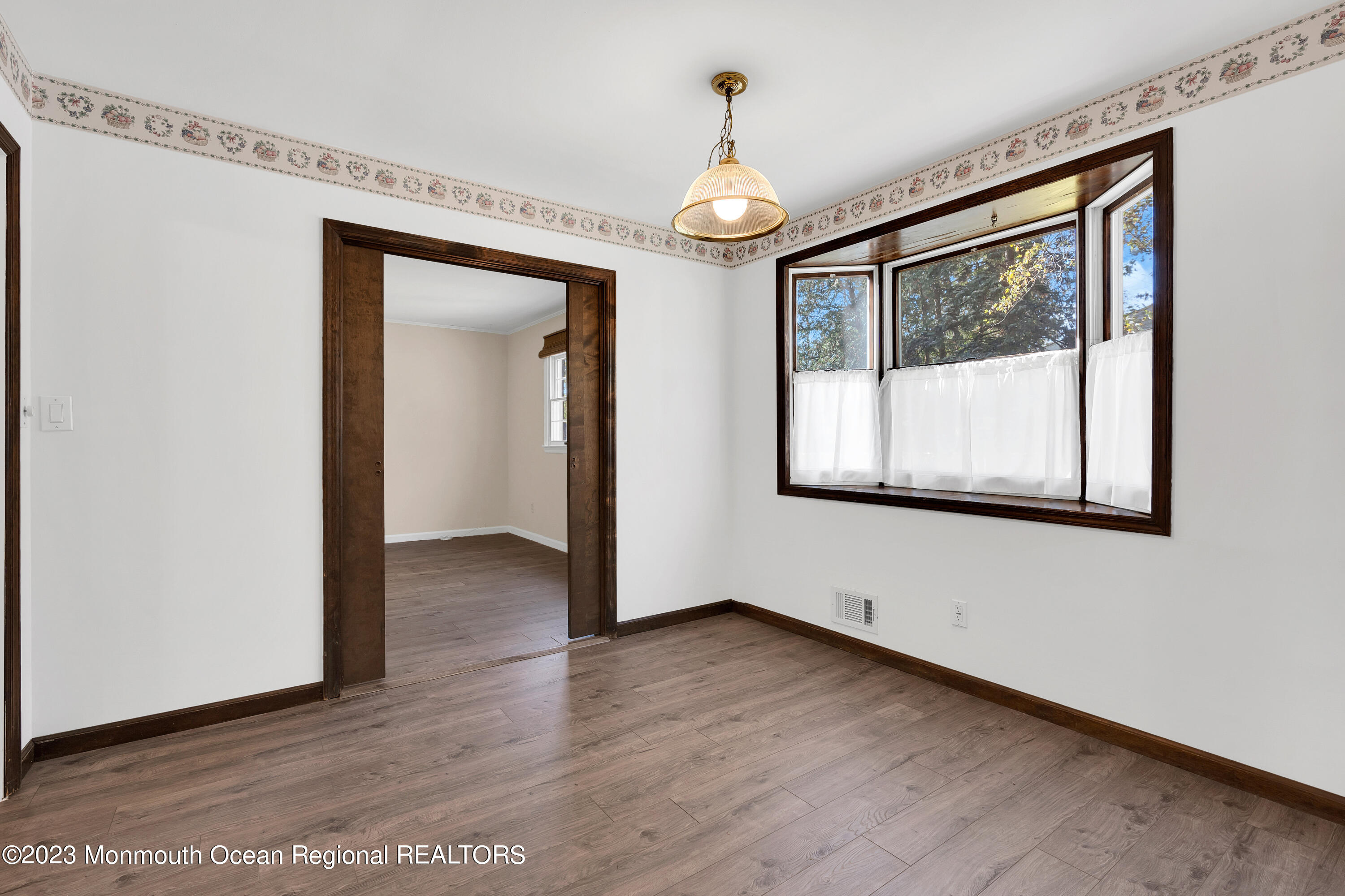 14 Daniel Drive Matawan, NJ 07747 - Photo 20 of 48 a view of an empty room with wooden floor and a window