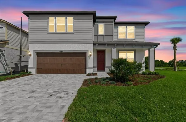 a front view of a house with a yard and garage
