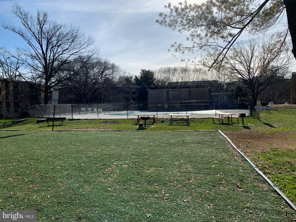 2911 Charing Cross Road, Unit 10 Falls Church, VA 22042 - Photo 18 of 25 a view of a tennis ground with large trees