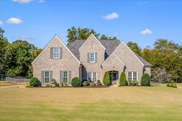 a front view of a house with yard and ocean view