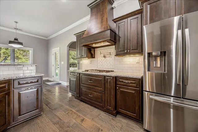 a kitchen with stainless steel appliances and cabinets