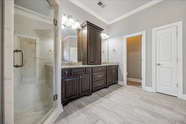 a bathroom with a granite countertop sink mirror and shower