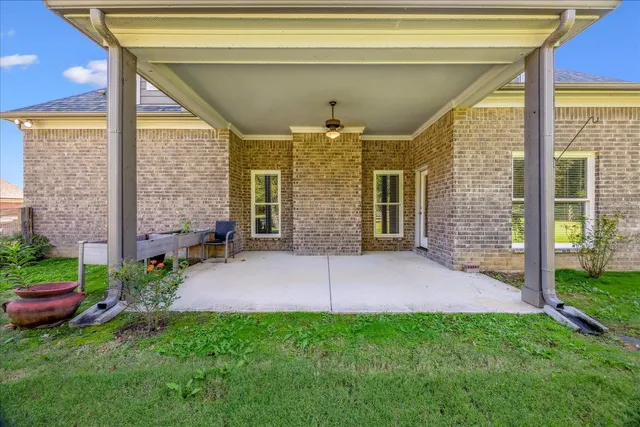 a view of a porch with a table and chairs