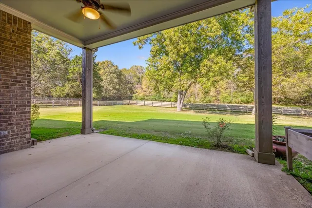 a view of a house with a big yard and potted plants