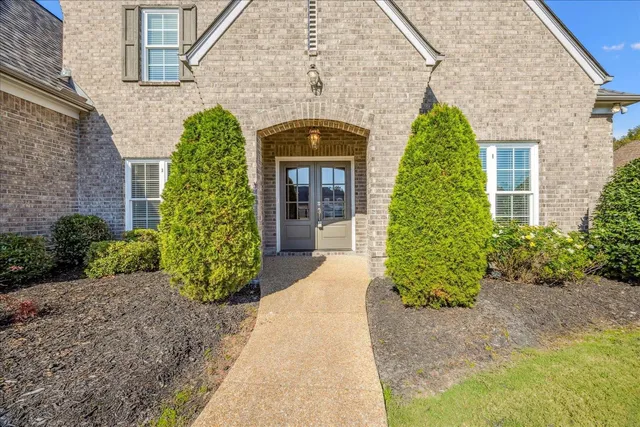 a front view of a house with a garden