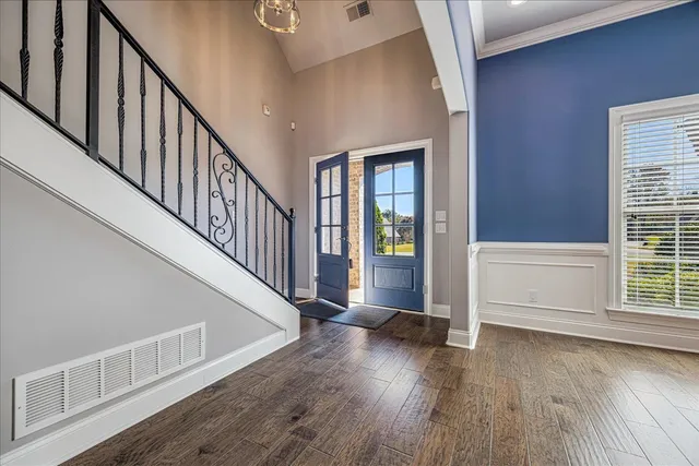 a view of an entryway with wooden floor