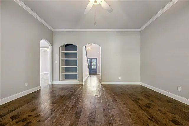 a view of a room with wooden floor closet and windows