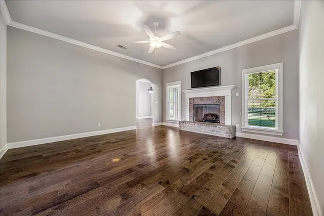 wooden floor fireplace and natural light in room