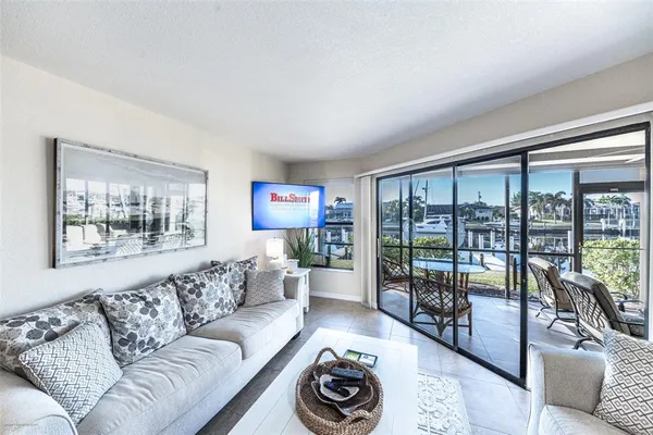 a living room with furniture and a floor to ceiling window