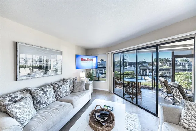 a living room with furniture and a floor to ceiling window