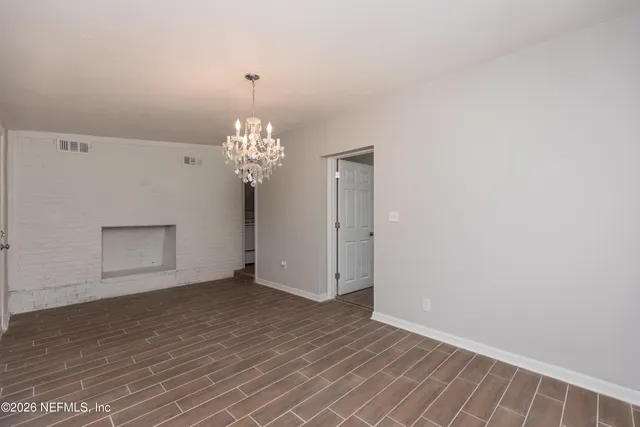 a view of an empty room with chandelier