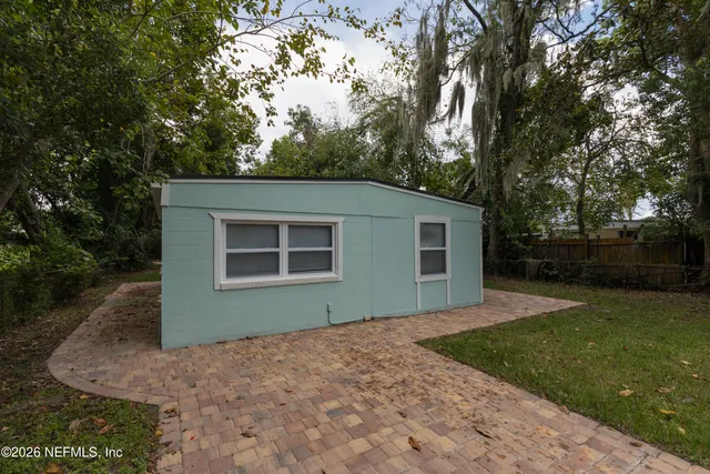 a front view of house with yard and trees