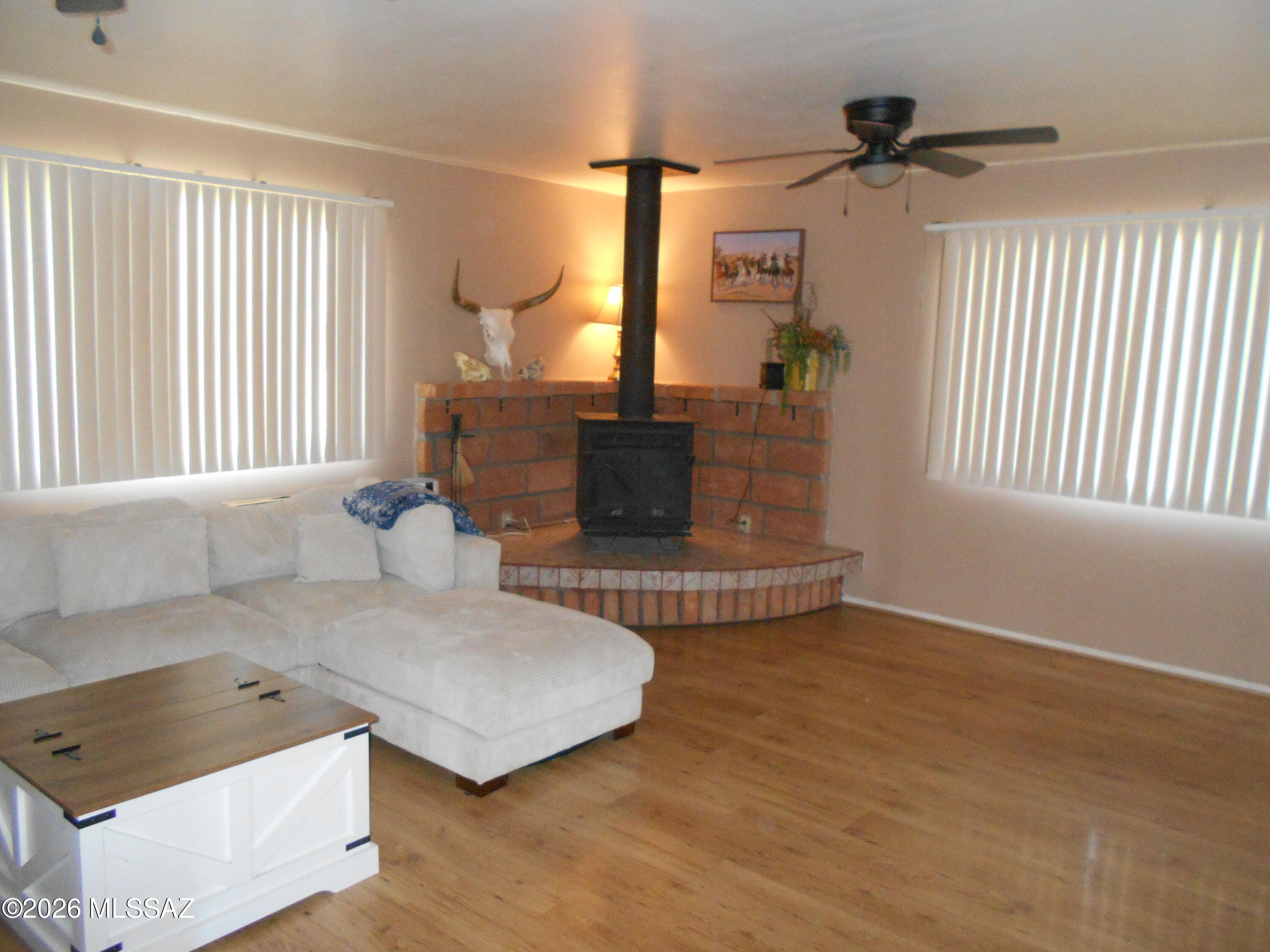 1201 East Old Stewart Road Willcox, AZ 85643 - Photo 15 of 49 an empty room with a fireplace and windows
