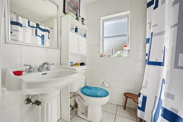 a bathroom with a sink toilet and mirror