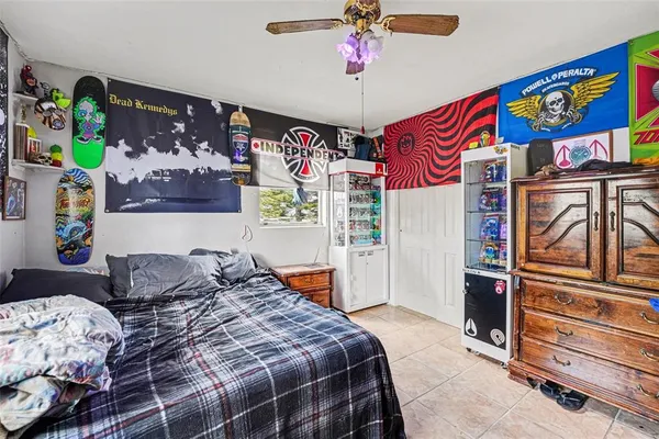 a bedroom with a bed and dresser with the shoe rack