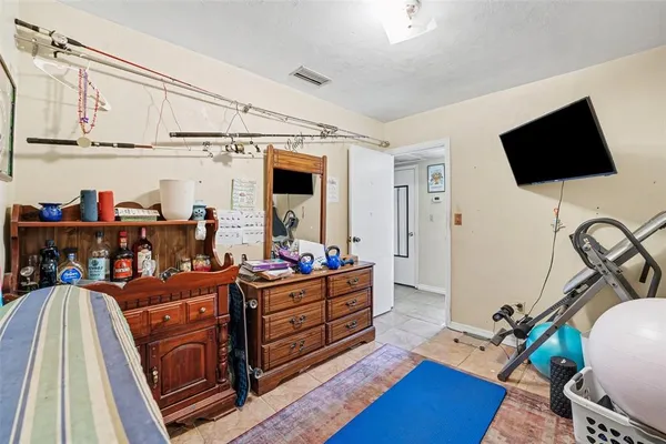 a bed room with furniture and a flat screen tv