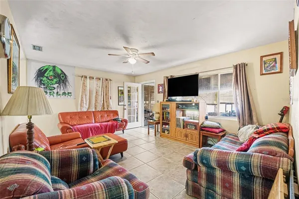 a living room with furniture workspace and a flat screen tv