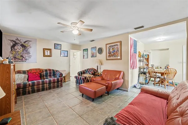 a living room with furniture and a glass door