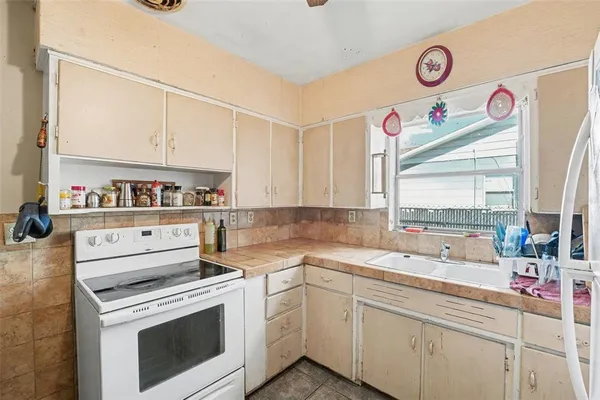 a kitchen with a stove a sink and a microwave