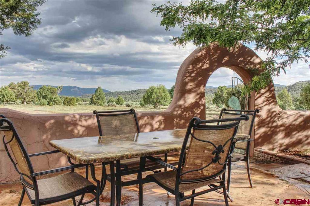 a view of a chairs and table in the patio
