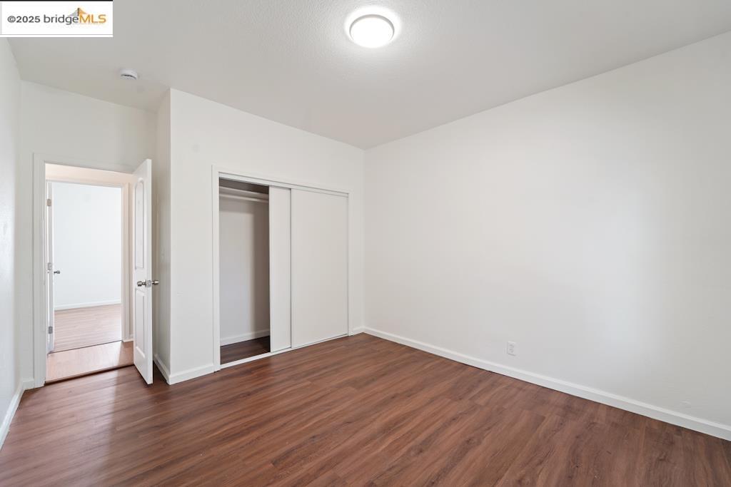 203 Bissell Avenue Richmond, CA 94801 - Photo 19 of 30 a view of an empty room with wooden floor
