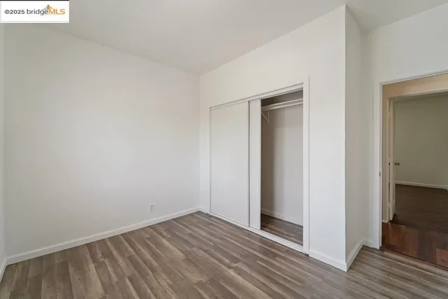 a kitchen with granite countertop a sink cabinets stainless steel appliances and a window