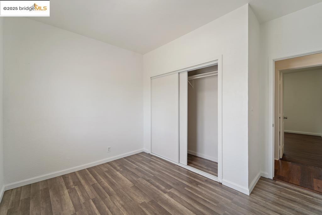203 Bissell Avenue Richmond, CA 94801 - Photo 25 of 30 a view of an empty room with wooden floor and closet