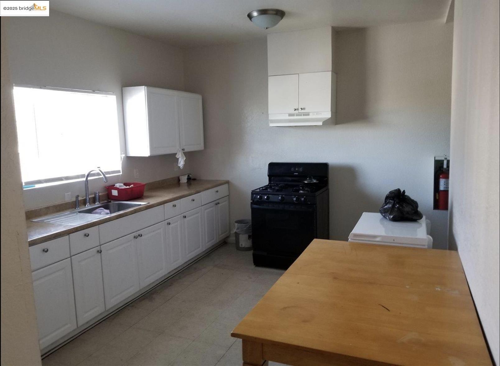 203 Bissell Avenue Richmond, CA 94801 - Photo 27 of 30 a kitchen with a sink and cabinets