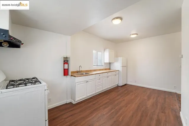 a kitchen with granite countertop a stove and a sink