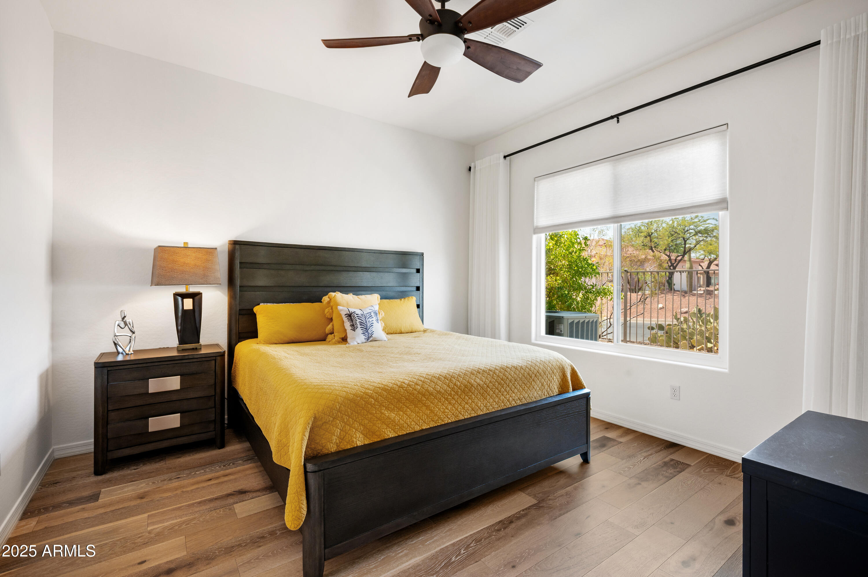 10172 East Dinosaur Ridge Road Gold Canyon, AZ 85118 - Photo 16 of 38 a bed sitting in a bedroom next to a window