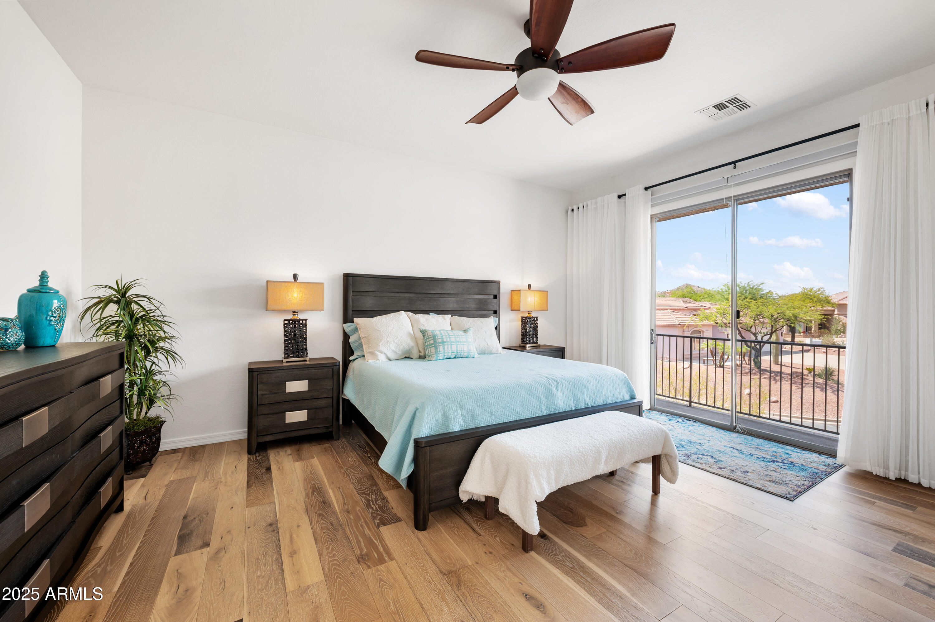 10172 East Dinosaur Ridge Road Gold Canyon, AZ 85118 - Photo 23 of 38 a bedroom with a bed and wooden floor