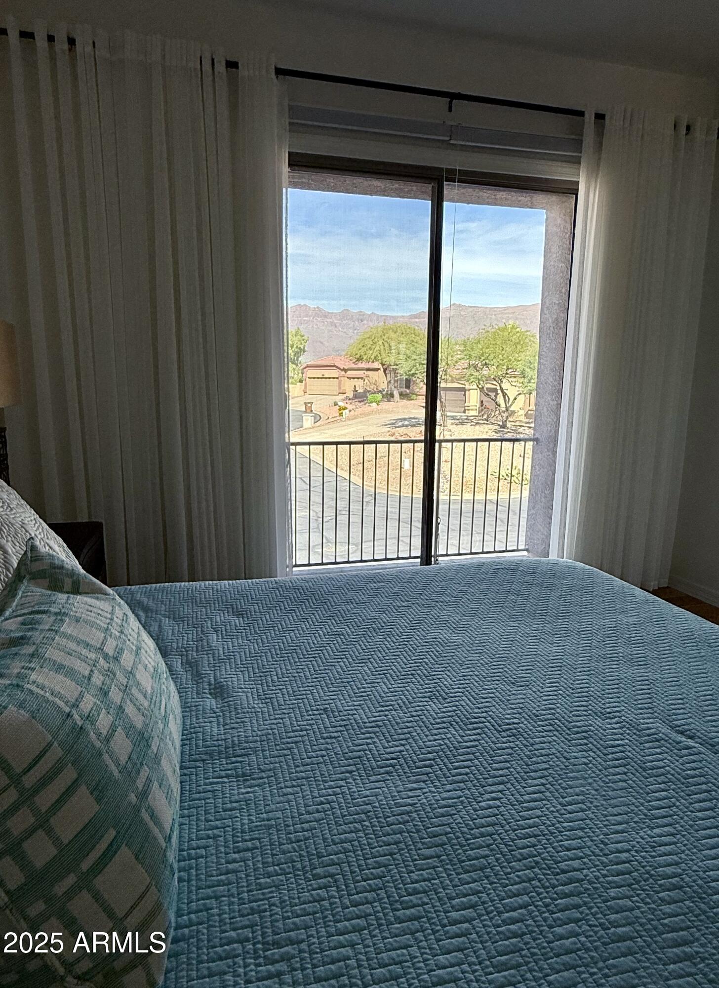 10172 East Dinosaur Ridge Road Gold Canyon, AZ 85118 - Photo 26 of 38 a bed sitting in a bedroom next to a window