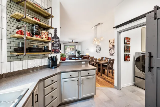a kitchen with stainless steel appliances granite countertop a refrigerator stove and sink
