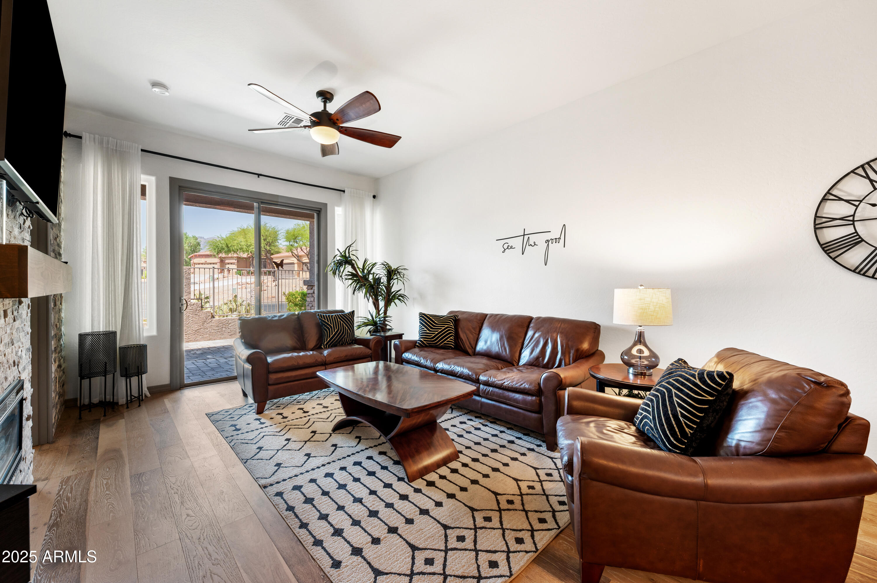10172 East Dinosaur Ridge Road Gold Canyon, AZ 85118 - Photo 7 of 38 a living room with furniture a fireplace and a flat screen tv