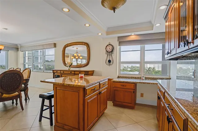 a kitchen with a stove a sink a dining table and chairs