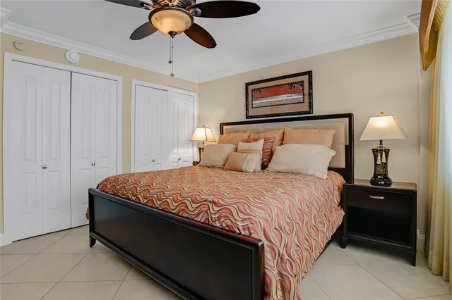a bedroom with a bed and a flat tv screen on dresser