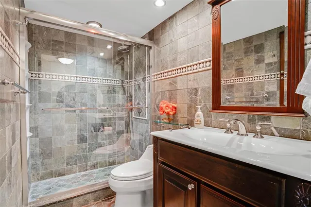 a bathroom with a sink a toilet and shower