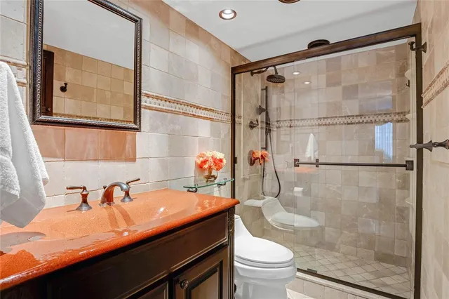 a bathroom with a sink toilet and shower