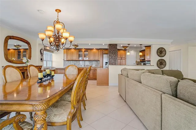 a dining room with furniture a chandelier and window