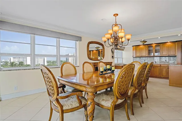 a view of a dining room with furniture and chandelier