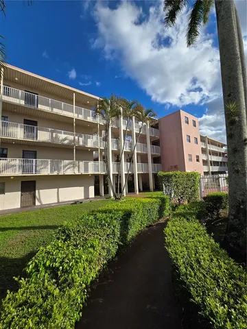 a view of a building with garden and plants