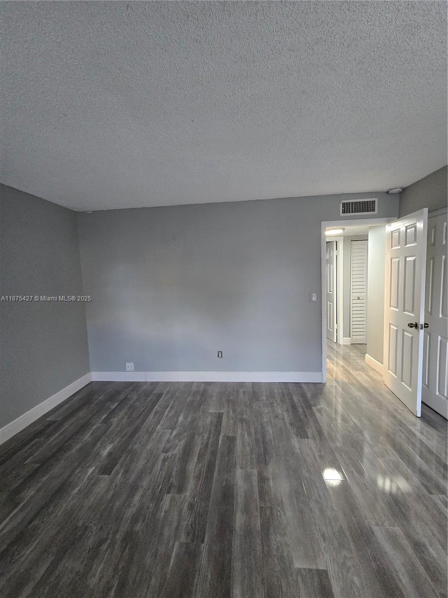 2800 Northwest 56th Avenue, Unit C104 Lauderhill, FL 33313 - Photo 16 of 17 a view of an empty room and wooden floor