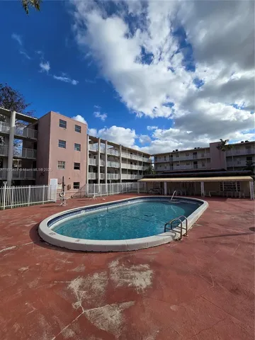 a view of outdoor space with swimming pool and seating
