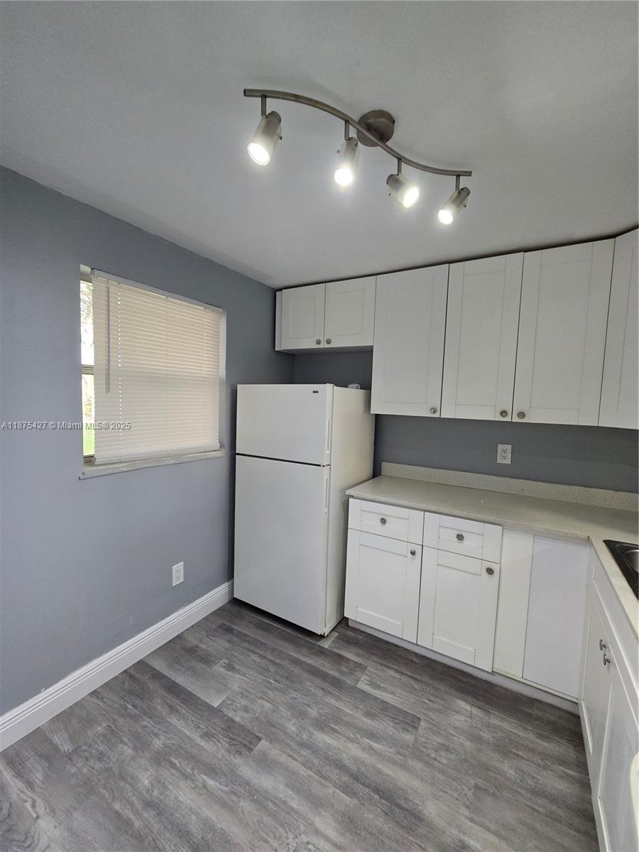 2800 Northwest 56th Avenue, Unit C104 Lauderhill, FL 33313 - Photo 6 of 17 a kitchen with granite countertop cabinets and white appliances